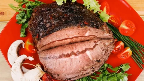 Beef on red plate over wood Video stock 88923251