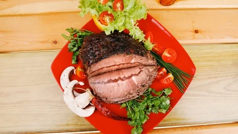 Beef on red plate over wood Video stock 88923385