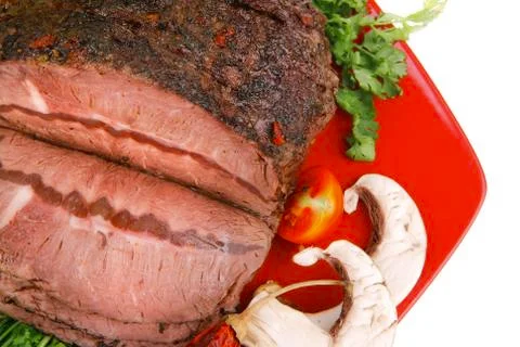 Beef on red plate with peppers Stock Photos
