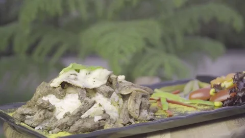Beef, rice, mozzarella cheese and vegetables rotating on plate. Stock Footage 78091536