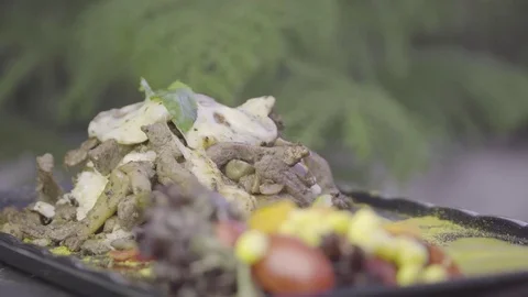 Beef, rice, mozzarella cheese and vegetables rotating on plate. Stock Footage 78091576