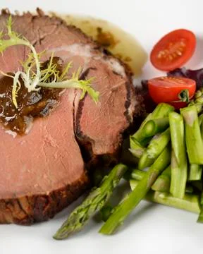 Beef roast with asparagus Stock Photos