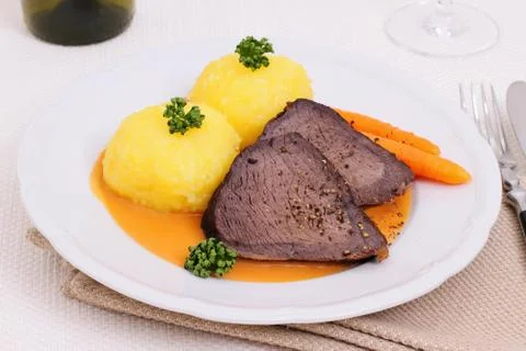 Beef roast with two dumplings in hunter sauce Stock Photos