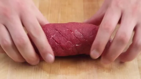 Beef roulade being fixed with roulade pins Stock Footage 24647422