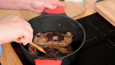 The beef roulades are roasted vigorously in the roasting pan and turned. Stock Footage 123584751