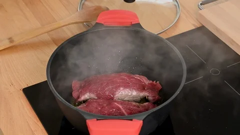 The beef roulades are roasted vigorously in the roasting pan. Stock Footage 123584904