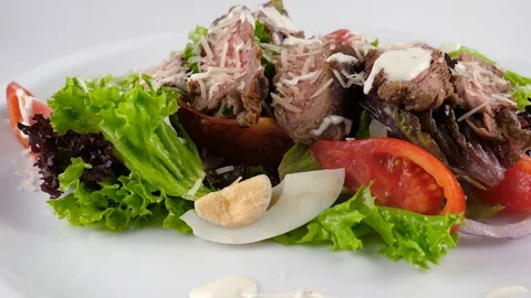 Beef salad with parmesan cheese, tomatoes, eggs and sauce Stock Footage 81004528