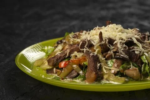 Beef salad with vegetables on black background Stock Photos