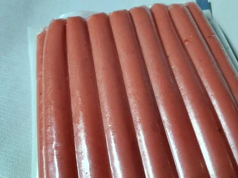 Beef sausage in plastic container. Фото