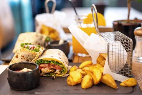 Beef shawarma wrap with vegetables. roasted potatoes and cream sauce on a plate Stock Photos