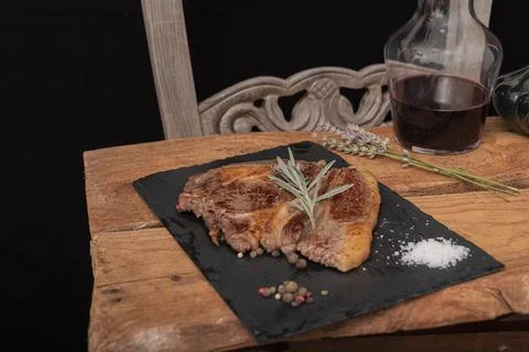 Beef on a slab of dark stone. Stock Photos