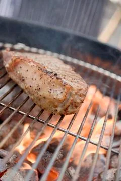 Beef steak on barbecue Stock Photos