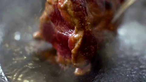Beef steak is being seared in a hot pan Video stock 333831206