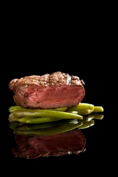 Beef steak on black background Stock Photos