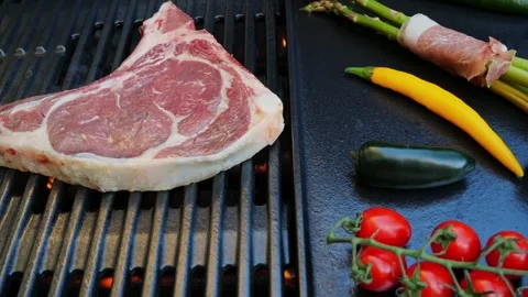 Beef steak with bone on cast iron grill barbecue. Top view Stock Footage 266822837
