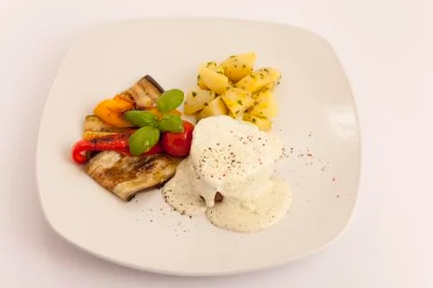 Beef steak on bread  with sauce, grilled vegetables and potato Stock Photos