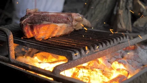 Beef steak is cooked on grill with sparks. Beef Rib BBQ Video stock 125818929