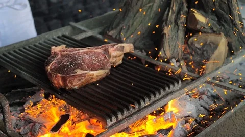 Beef steak is cooked on grill with sparks. Beef Rib BBQ Stock Footage 125819979