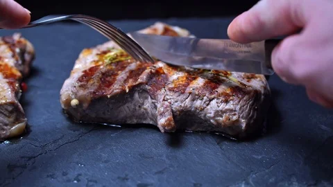 Beef steak cooked medium cut with a knife Stock Footage 118185907