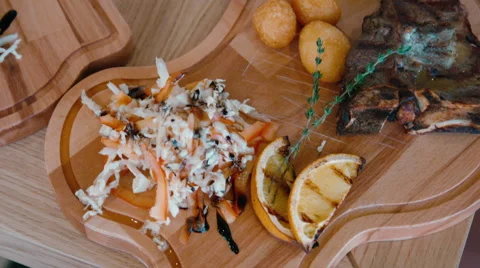 Beef steak cooked to medium rare on wooden background. 4K footage Stock Footage 58506527