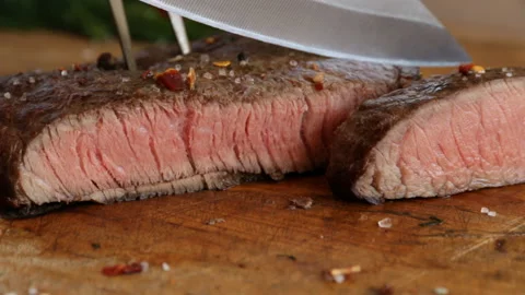 Beef steak cooked medium well cut sliced knife Stock Footage 89877812