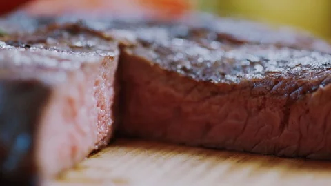 Beef steak cooked medium well cut sliced knife on a cutting board roast fillet Stock Footage 100304542
