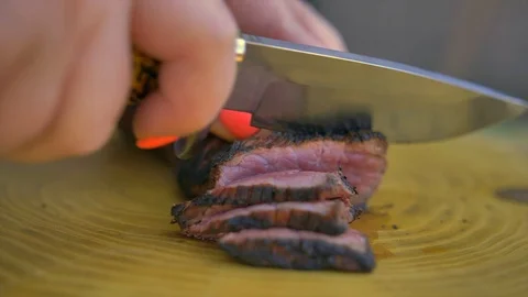 Beef steak cooked medium well cut sliced knife Stock Footage 128759287