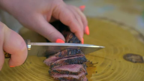 Beef steak cooked medium well cut sliced knife Stock Footage 128759562