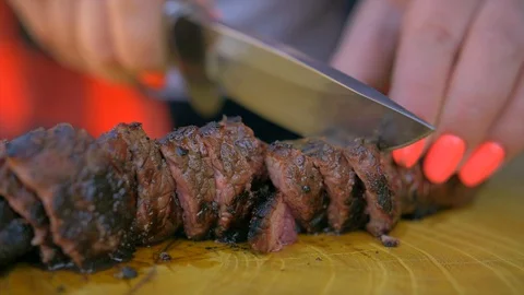 Beef steak cooked medium well cut sliced knife Stock Footage 128760461