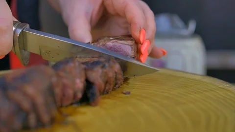 Beef steak cooked medium well cut sliced knife Stock Footage 128760695