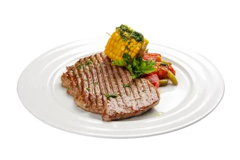 Beef steak with corn and vegetables. On a white background Stock Photos