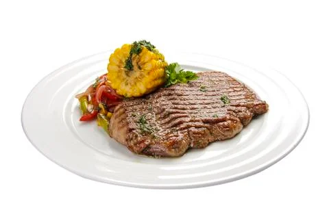 Beef steak with corn and vegetables. On a white background Stock Photos