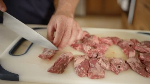 Beef steak cubes being sliced up for use in recipe Stock Footage 123733574
