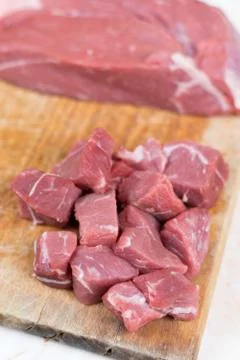 Beef steak cut into cubes. Red meat on the cutting board Stock Photos