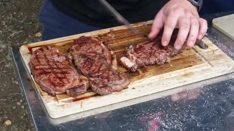 Beef steak is cut with a knife. Stock Footage 181442556
