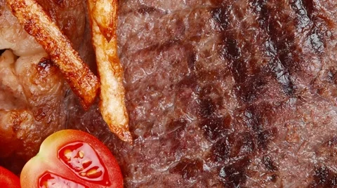 Beef steak on dark plate with red hot chili pepper Vídeos de archivo 55787341