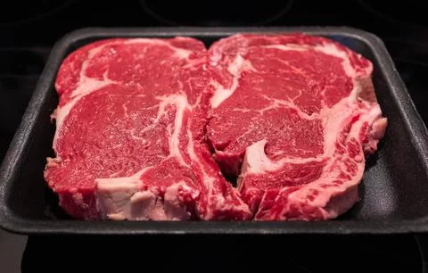 Beef steak. Fresh raw beef steak isolated on black background, top view. Ra.. Stock Photos
