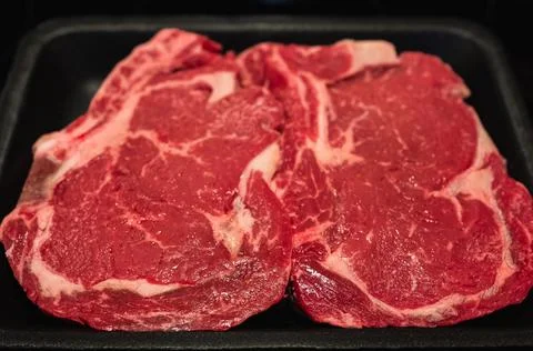 Beef steak. Fresh raw beef steak top view. Raw rib eye steaks on styrofoam .. Stock Photos