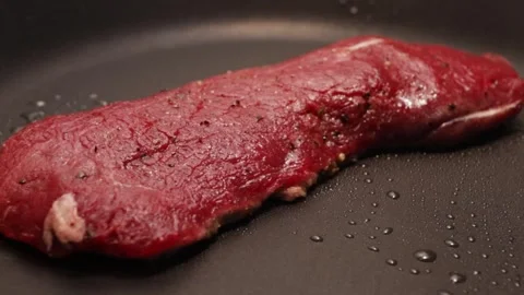 Beef steak fried in a frying pan close-up Stock Footage 258026523
