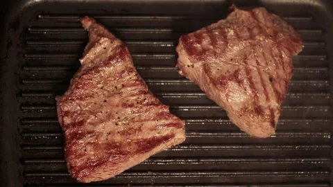 Beef steak is fried in a pan. Stock Footage 153873385