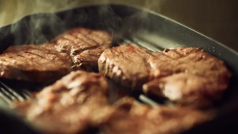 Beef steak fried in pan with steam. selective focus. slow motion Video stock 78715948