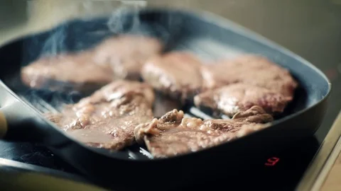 Beef steak fried in pan with steam. selective focus. slow motion Video stock 78717757