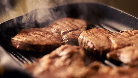 Beef steak fried in pan with steam. selective focus Video stock 78717784