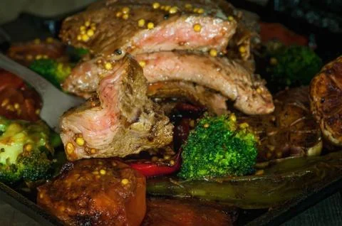 Beef steak on a grill with vegetables Stock Photos