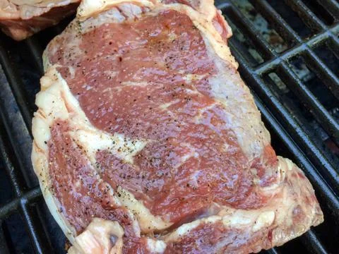 Beef steak on grille Stock Photos