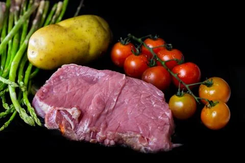 Beef steak grilling on back background Foto stock
