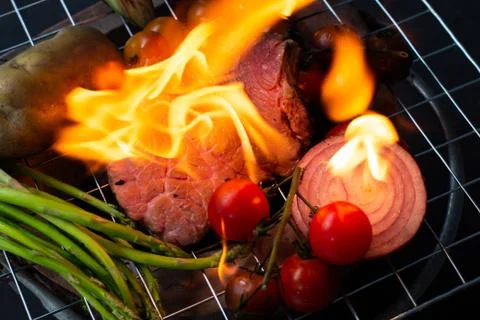 Beef steak grilling on back background Stock Photos