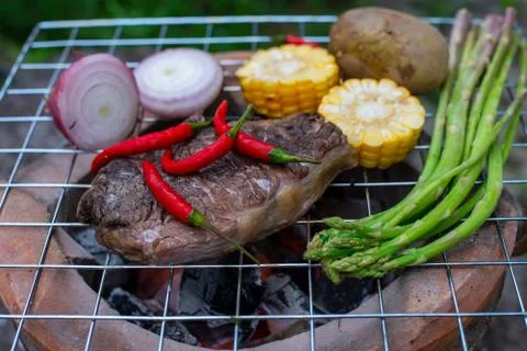 Beef steak grilling Stock Photos