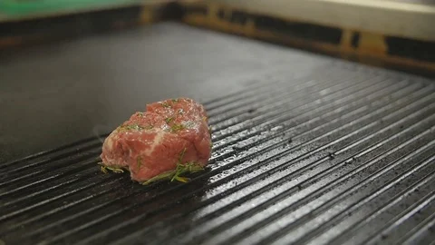 Beef steak is grilling at restaurant kitchen Stock Footage 75410460