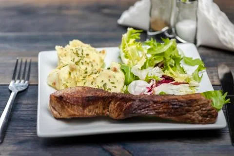 Beef steak with mashed potatoes and rocket salad Stock Photos